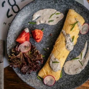 French omelette with tomato onion confit and spicy sour cream