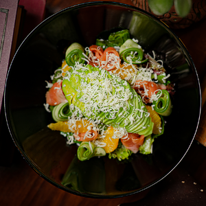 Salad with half-smoked salmon, avocado and orange segments