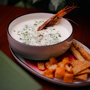 Creamy soup with salmon and langoustines