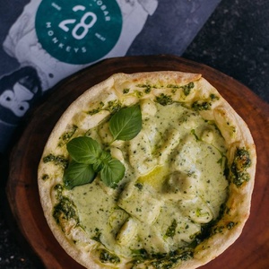 Gnocchi in a bread bowl with pesto sauce